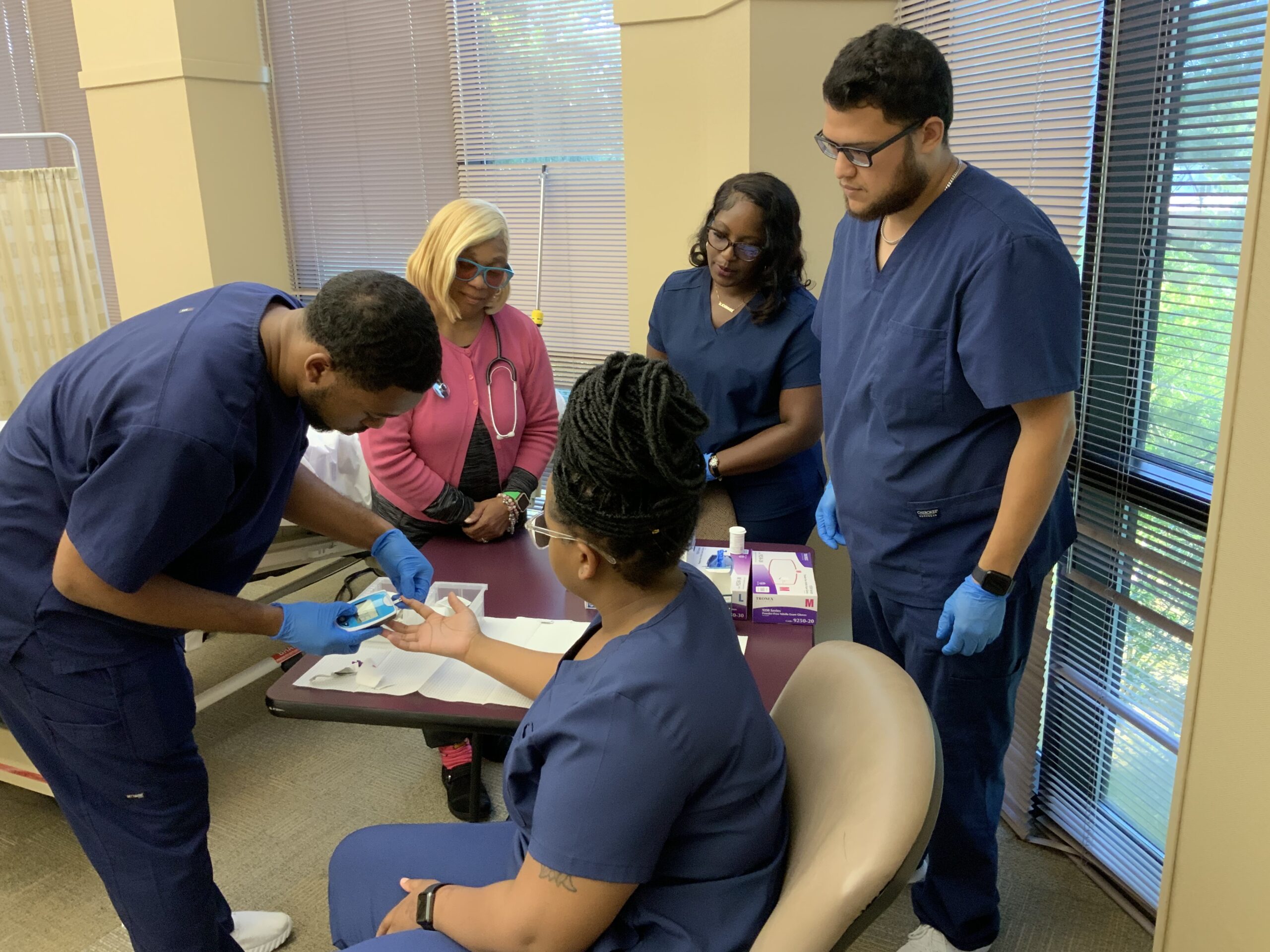 medical assistants helping a patient