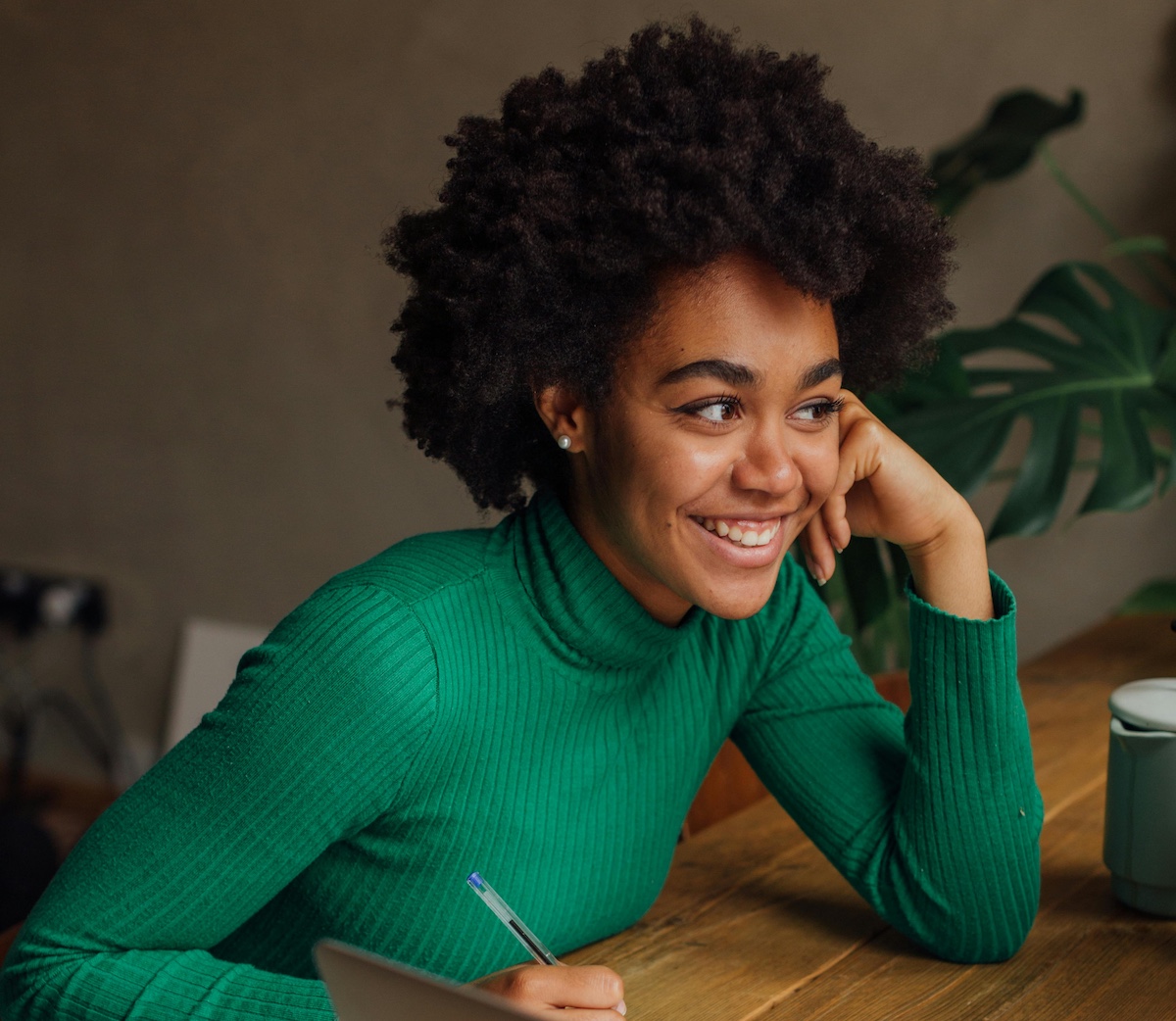 young african american woman sitting at a desk and smiling